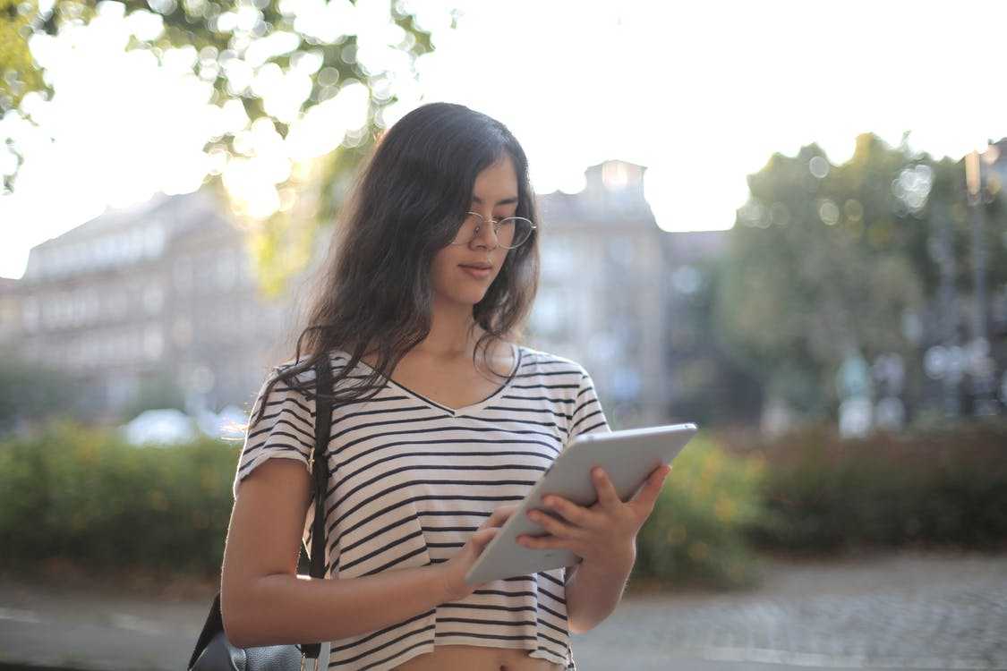 A girl swiping on her tablet